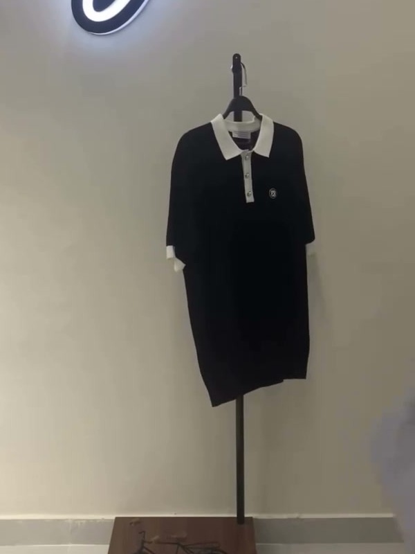 Black knit polo with a white collar